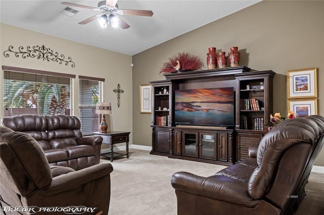 carpeted living room with lofted ceiling and ceiling fan