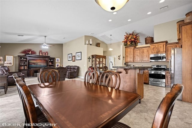 dining area featuring ceiling fan and lofted ceiling