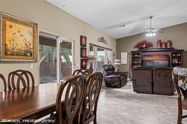 tiled dining room featuring lofted ceiling and ceiling fan