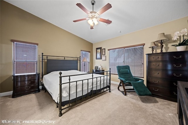 carpeted bedroom with ceiling fan and vaulted ceiling