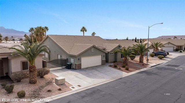 ranch-style home with a garage and a mountain view