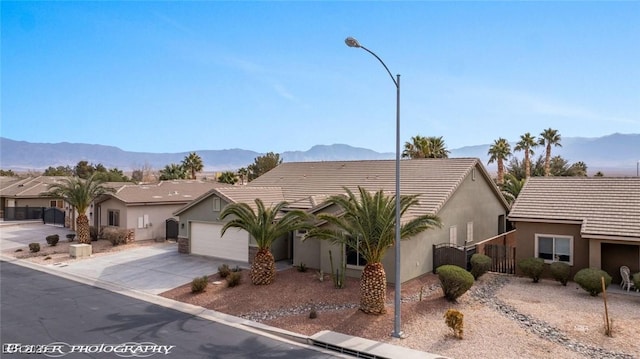 view of front of house featuring a garage and a mountain view