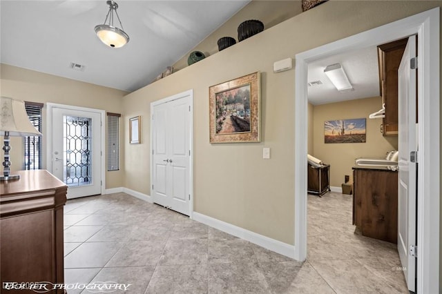 tiled entrance foyer with lofted ceiling