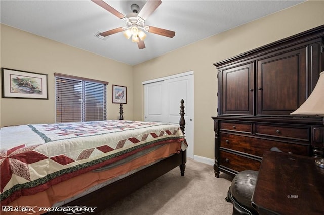 carpeted bedroom featuring a closet and ceiling fan