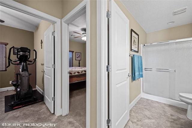 bathroom with ceiling fan, a shower, and toilet