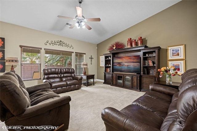 carpeted living room featuring ceiling fan and vaulted ceiling