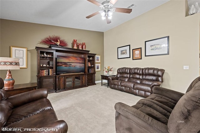 carpeted living room with ceiling fan