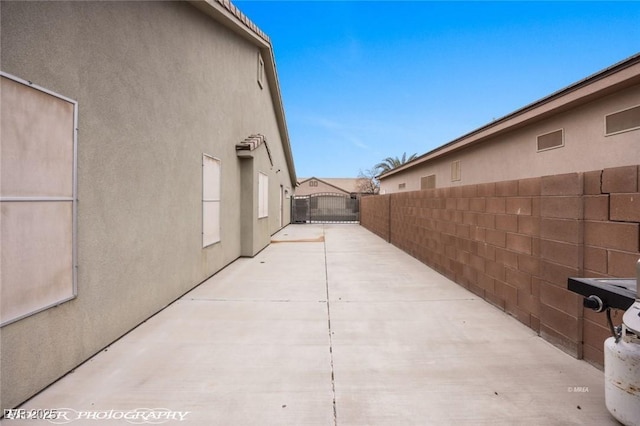 view of side of property with a patio area