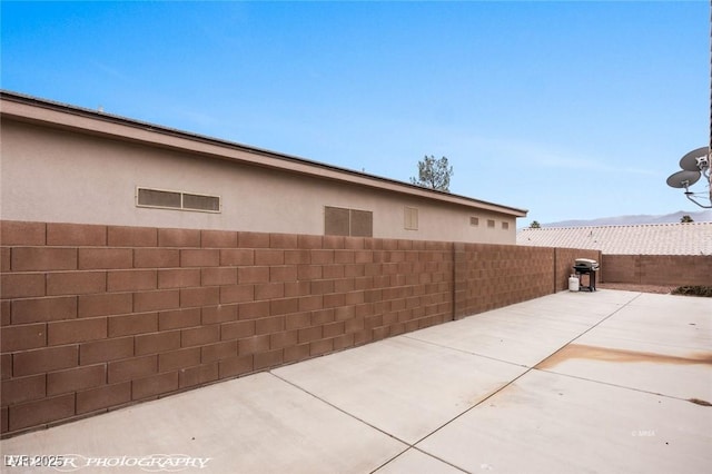 view of side of property featuring a patio