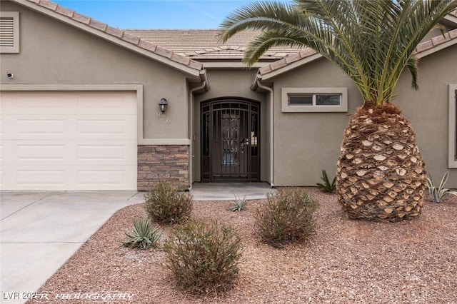 view of exterior entry with a garage