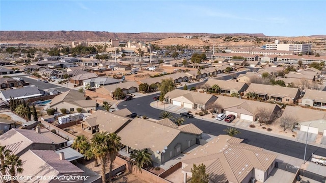 birds eye view of property with a mountain view