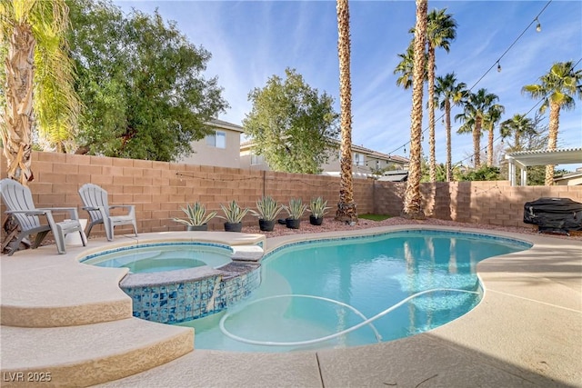 view of pool with a pool with connected hot tub, a fenced backyard, and a patio