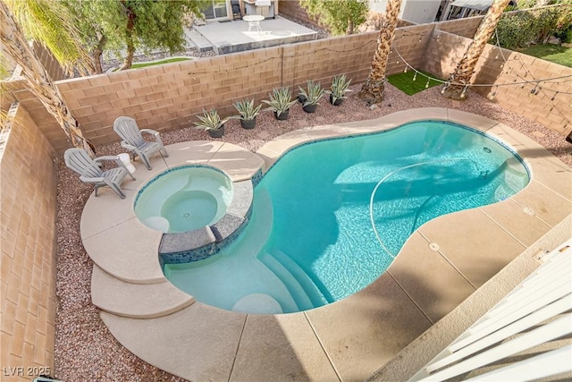 view of swimming pool with a patio area, a fenced backyard, and an in ground hot tub