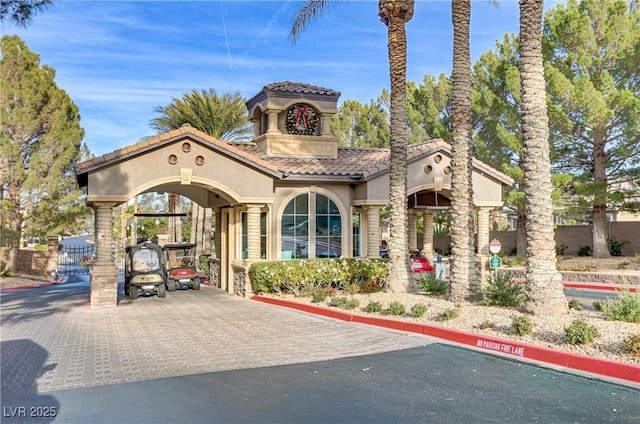 view of property featuring decorative driveway