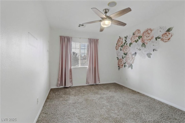 carpeted spare room with visible vents, a ceiling fan, and baseboards