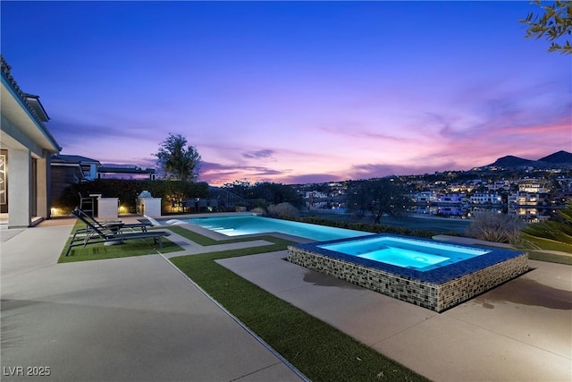 view of pool featuring an infinity pool, an in ground hot tub, and a patio