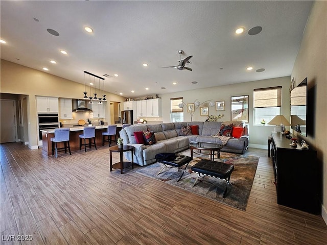 living room with lofted ceiling, hardwood / wood-style flooring, and plenty of natural light