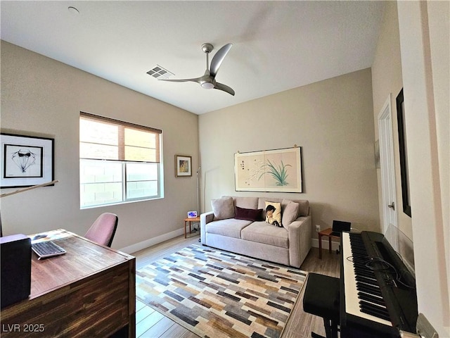 office space featuring ceiling fan and light hardwood / wood-style flooring