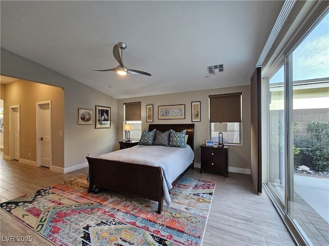 bedroom featuring access to exterior, vaulted ceiling, light hardwood / wood-style floors, and ceiling fan