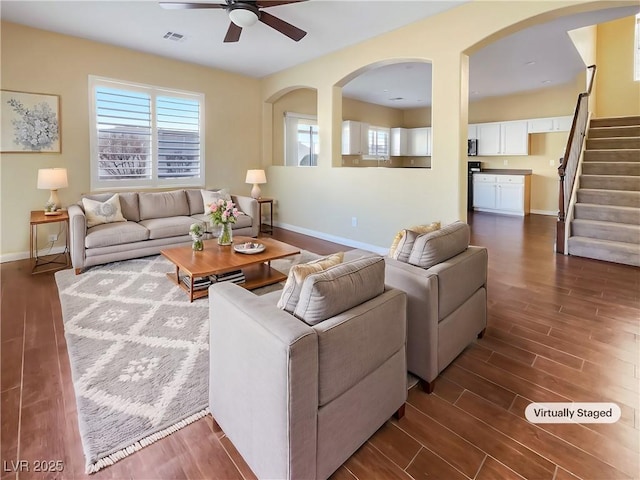 living room with ceiling fan and dark hardwood / wood-style flooring