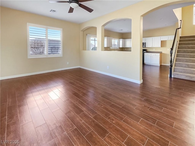 unfurnished room featuring dark wood-type flooring and ceiling fan