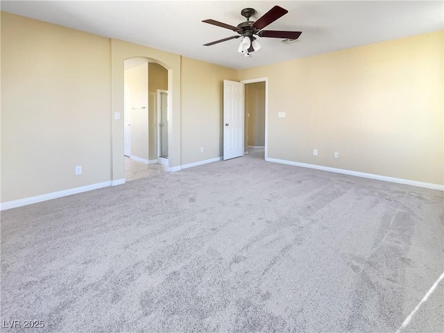 empty room with light colored carpet and ceiling fan