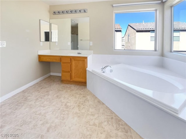 bathroom with vanity, tile patterned flooring, and a washtub