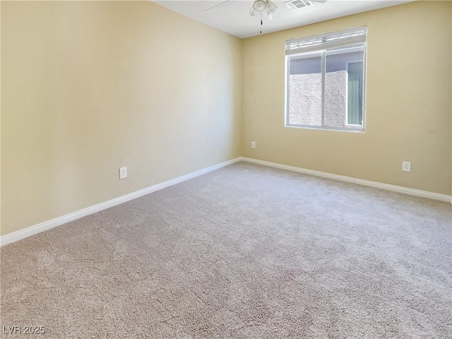 spare room featuring ceiling fan and carpet