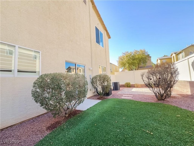 view of yard featuring central AC unit and a patio area