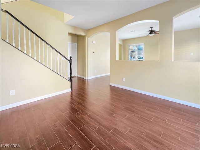 empty room featuring dark hardwood / wood-style floors and ceiling fan