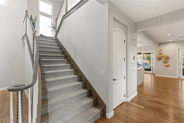 stairway with hardwood / wood-style floors