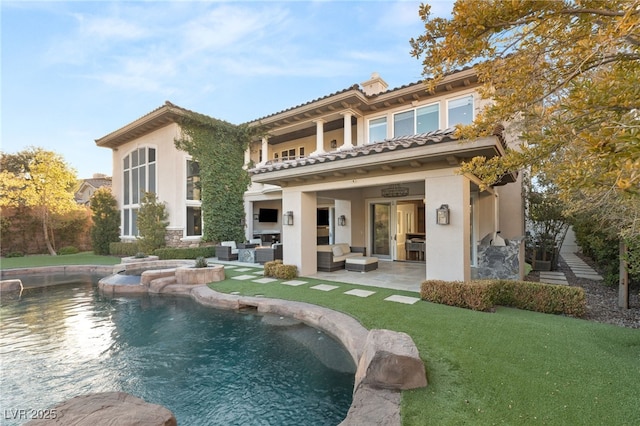 back of property featuring an outdoor living space, a yard, and a patio