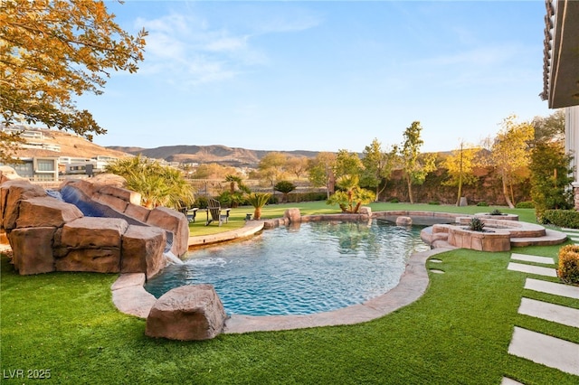 view of pool featuring a mountain view, a lawn, and pool water feature