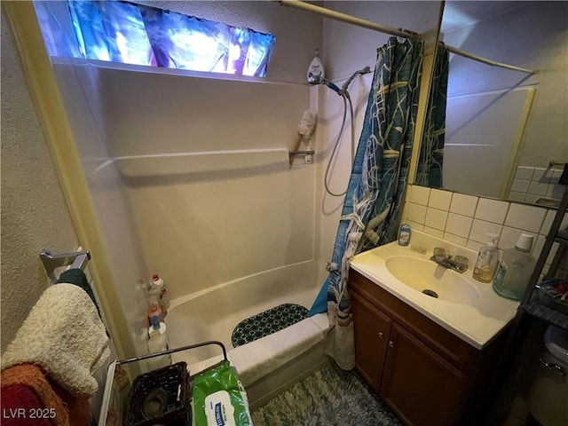 full bathroom with shower / bathtub combination with curtain, vanity, toilet, and backsplash