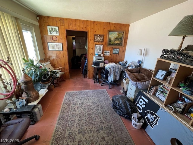 tiled living room featuring wood walls