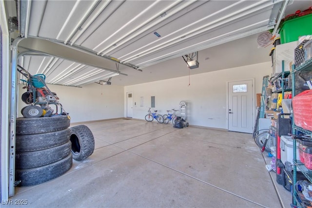 garage featuring a garage door opener and electric panel