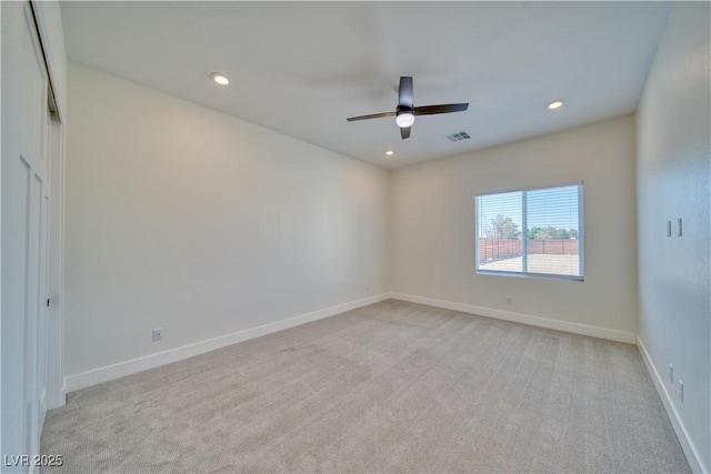 unfurnished room featuring ceiling fan and light carpet