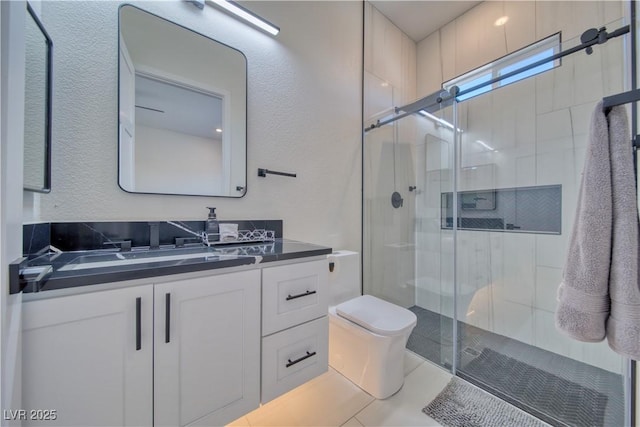 bathroom featuring vanity, toilet, and an enclosed shower