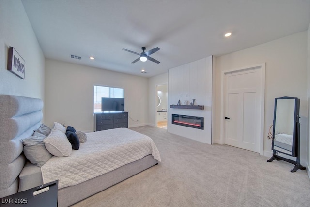 carpeted bedroom with ceiling fan and ensuite bathroom