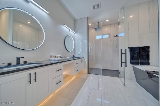 bathroom with vanity and a shower with door