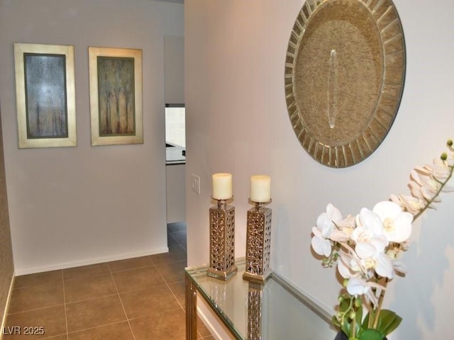 hallway featuring dark tile patterned floors