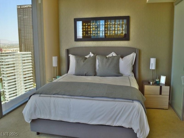 carpeted bedroom featuring multiple windows