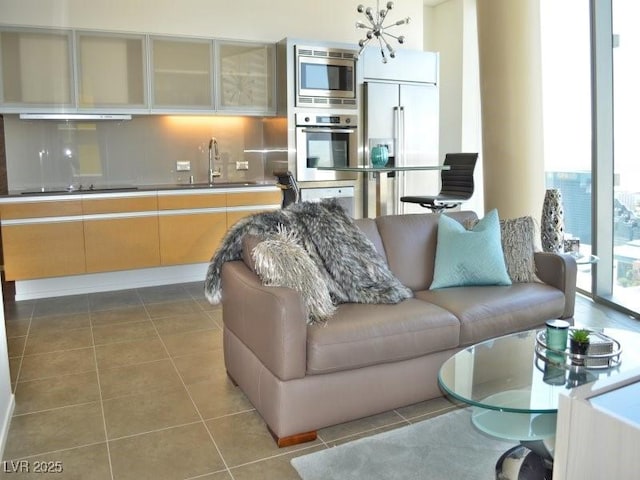 living room featuring tile patterned flooring and sink