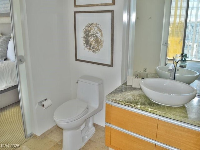 bathroom featuring tile patterned flooring, vanity, and toilet