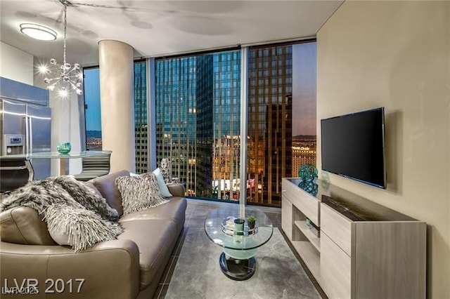 living room with a notable chandelier and floor to ceiling windows