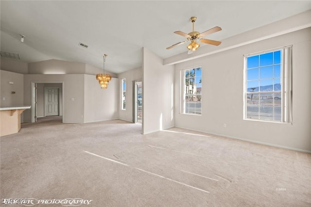 unfurnished living room with light colored carpet, lofted ceiling, and ceiling fan with notable chandelier