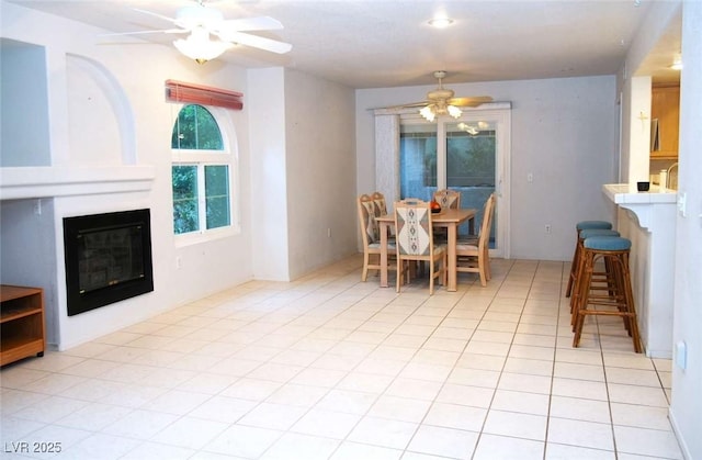 tiled dining room with ceiling fan