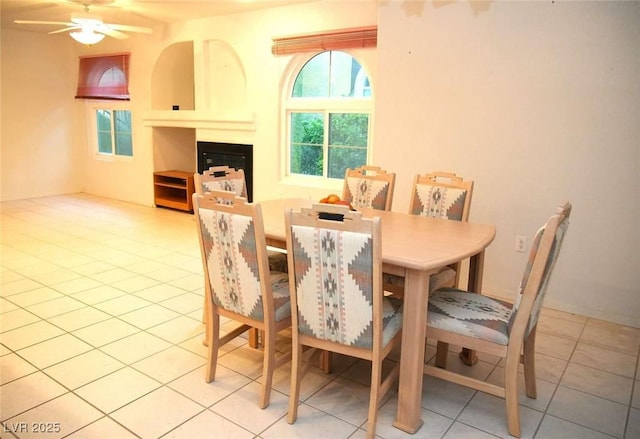 dining space featuring light tile patterned floors and ceiling fan