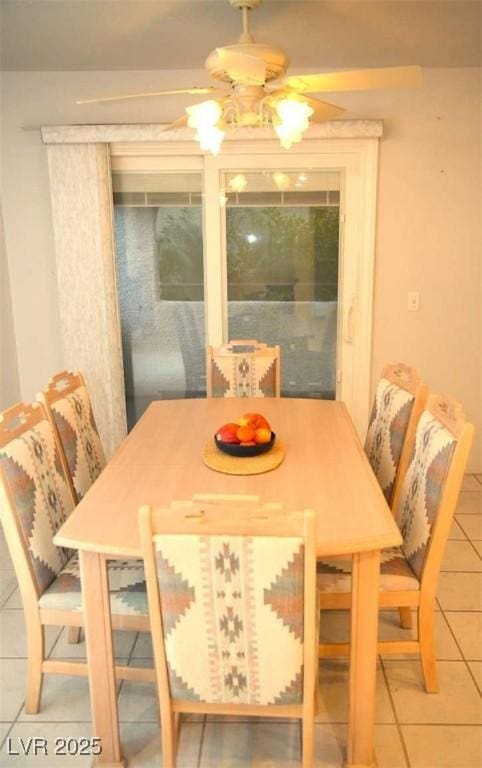 dining area featuring tile patterned flooring and ceiling fan