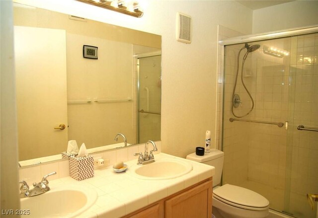 full bathroom with a sink, visible vents, toilet, and a shower stall